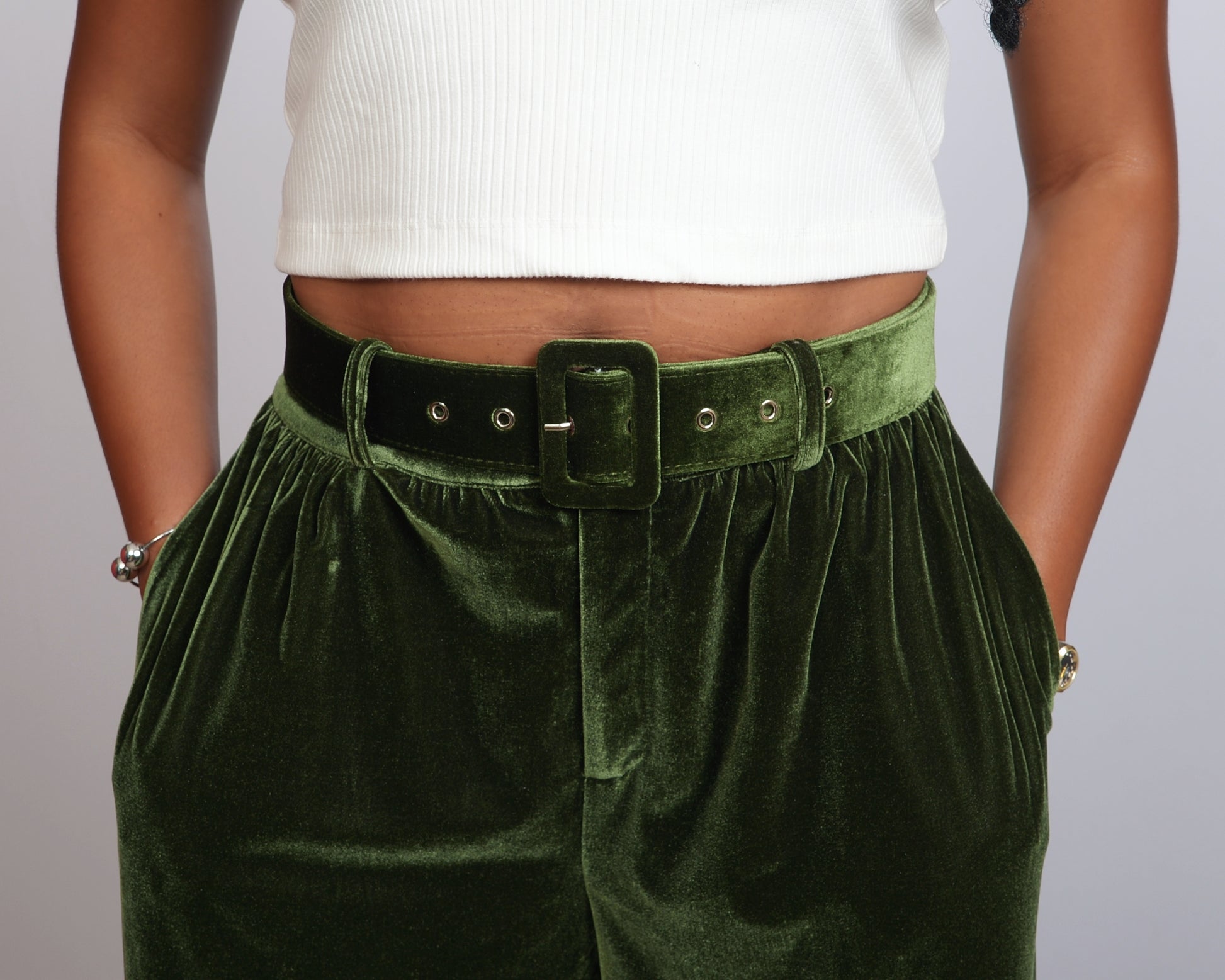Detailed front view of green velvet pants with matching belt, made exclusively for tall women.