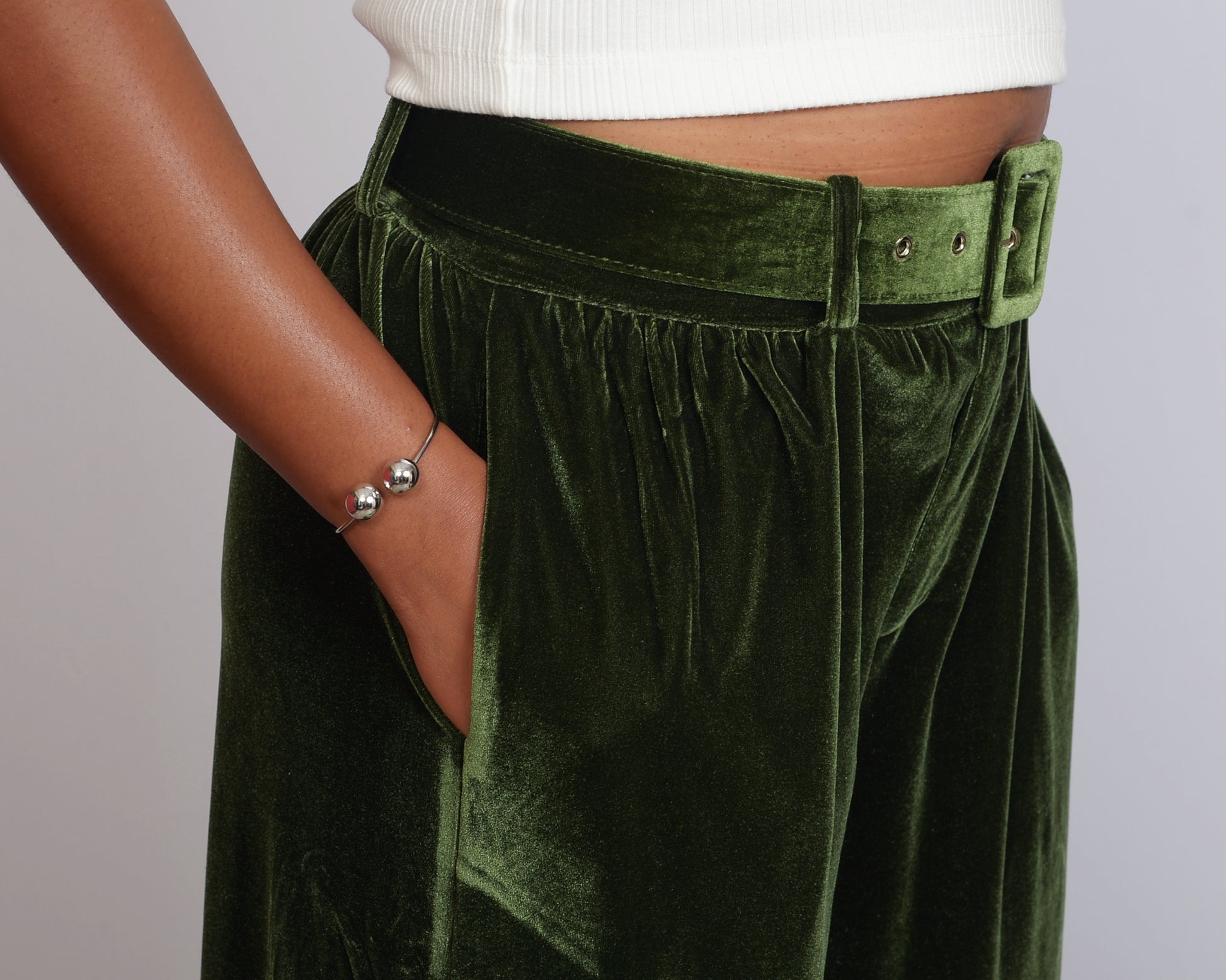 Detailed side view of green velvet pants with matching belt, made exclusively for tall women.